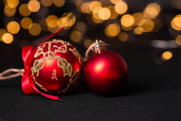 Red christmas ball on light abstract background. Christmas greeting card. Soft focus. Copy space