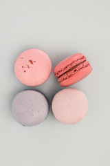 Four macaroons on the blue background. French cake. Top view.