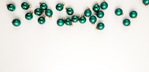 Green matte and glossy Christmas balls on a white background