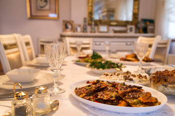  very nicely prepared dining table for special, valentines' day or Ramadan or Christmas in the luxury living room. Pasta,macaroni,salads,pizza on the table for party time.