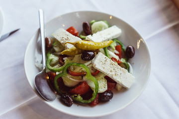 On the plate is a Greek salad.