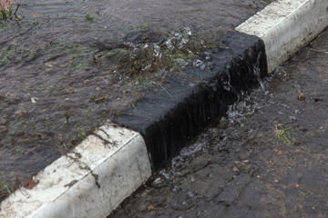 Accident of water supply, sewage. From under the crack in the asphalt poured a water fountain of...