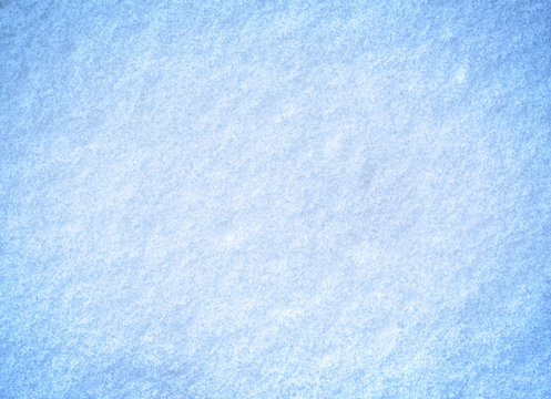 White snow in freezing blue tone on ground for background.