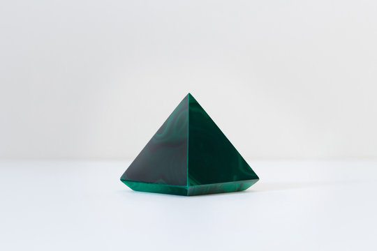 Green malachite gemstone polished with a pyramid form
