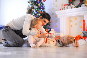 family, christmas, x-mas, happiness and people concept - smiling father and daughter holding gift box