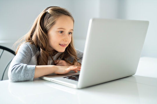 A Young girl using laptop at home