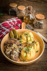 Fried chicken liver with onion served with mashed potatoes and pickled cucumber.