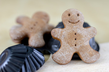 Tasty gingerbreads on a wooden table in the kitchen. Small cookies for Christmas.