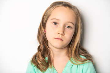 A Portrait of a child girl sad on studio white