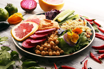 Bowl of Buddha, The concept of a healthy diet: chickpeas, salad, beetroot, pumpkin, cucumber, grapefruit, cabbage and tabouleh. Balanced food.