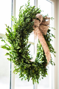 Christmas boxwood wreath at window