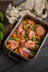 Prepared for baking chicken meat with vegetables.