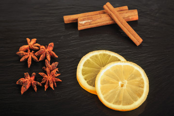 Fototapeta na wymiar cinnamon sticks, star anise and lemon