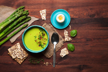 Cream soup with asparagus and cream, near boiled asparagus, egg and diet breads. Useful and tasty low-calorie diet dinner