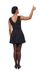 Back view of a black woman showing thumb up.
