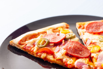 Detail shot of two slices of pepperoni pizza