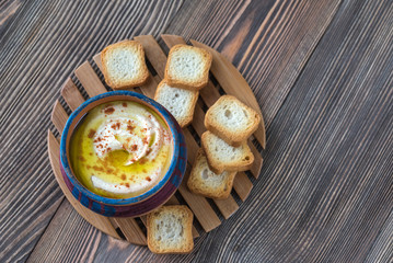 Bowl of hummus with toasts