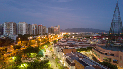 Aerial view of the city buildings at night, with the lights of the streets accessed