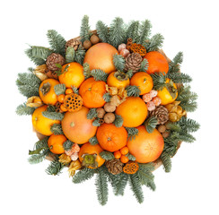 Original Christmas gift in the form of a bouquet consisting of tangerines, oranges, grapefruit, persimmon, walnuts, decorated with twigs of fir. Top view