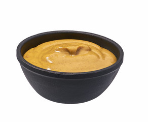 Mustard sauce  in  black bowl isolated on white