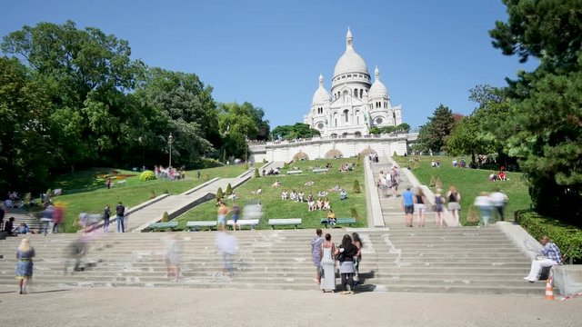 In September 2018, in Paris, France. View on the basilica of the Sacré-Cœur on the Montmartre hill. There are people moving around. Time lapse. (Each image is a one-second long exposure).