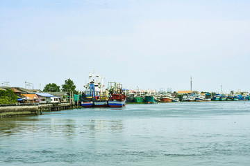 Fototapeta na wymiar Many colorful cargo and passenger boat park on the river, Wooden ship on riverside port