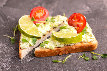 Toasts with avocado pate, fresh microgreen and cherry tomatoes
