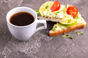 Toasts with avocado pate, fresh microgreen, cherry tomatoes