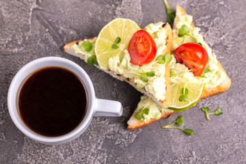 Toasts with avocado pate, fresh microgreen, cherry tomatoes