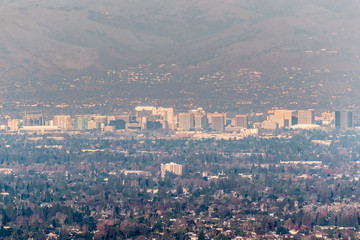 Fototapeta na wymiar Aerial view of downtown San Jose on a sunny afternoon; Silicon Valley, south San Francisco bay area, California; pollution and smog visible in the air
