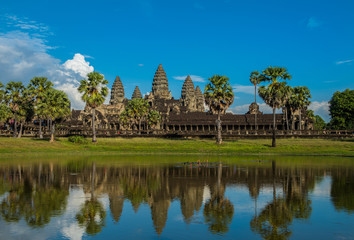Fototapeta na wymiar Angkor Wat temple in Cambodia with water reflection at blue sky. 