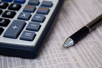 Calculator with pen on paper.
