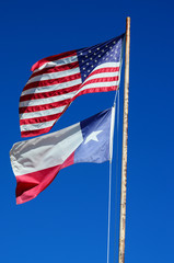 Flags of Texas and USA  against Clear Blue Sky