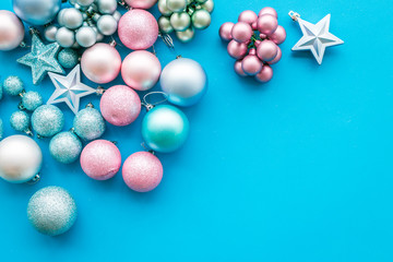Toys for New Year tree 2019 background. Blue and pink balls and stars on blue background top view space for text border