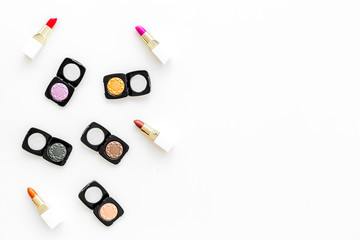 Professional cosmetics set with palette of eyeshadows on white background top view copyspace