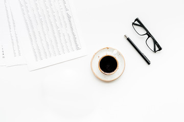 Breakfast in office with coffee on the work desk with documents and glasses on white background top view space for text