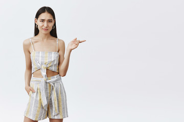 Girl not sure new model fits in squad. Portrait of unsure and doubtful displeased female in trendy...