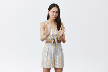 Keep it away from me, I am on diet. Portrait of intense displeased and worried cute asian female in...