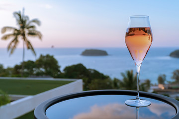 Rose wine or Gin and Tonic or apiro cocktail, night light over city background, Christmas festive celebration. End of the year, Welcome to New Year 2019. Good long holiday vacation with new thing.