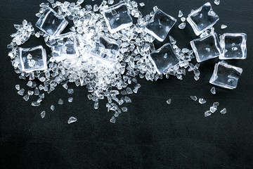 Frozen water in ice cubes on black bar table top view mockup