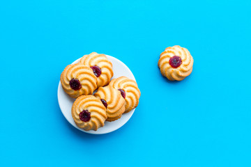 Homemade cookies. Kurabe in glass bowl on blue background top view copy space