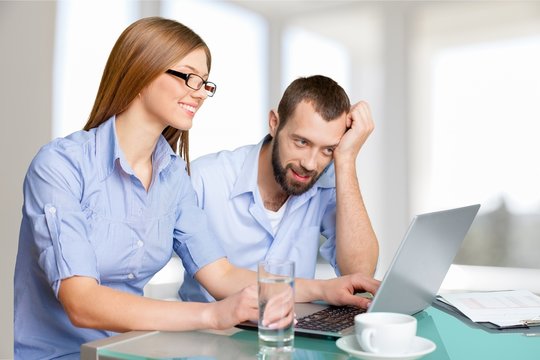 Portrait of cheerful Couple on the couch using laptop