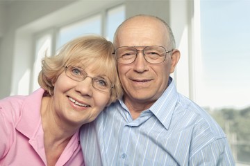 Portrait of happy senior couple smiling at home