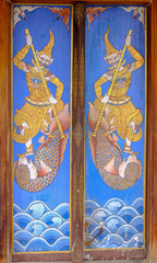 Wooden ancient Thai Style Door of ordination hall at Wat Poramaiyikawas Worawihan, Koh Kret, Nonthaburi