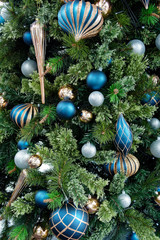 Beautiful Christmas decorations hanging off a green tree