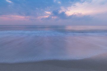 Fototapeta na wymiar long exposure motion wave and morning sunrise in Chaweng beach in Samui island, Thailand