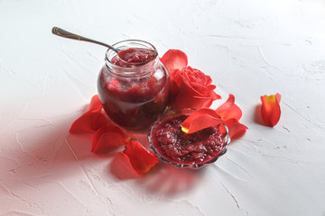 Rose jam in a jar on the table, top view