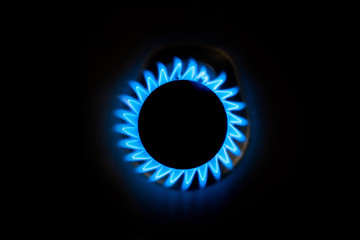 Natural gas burning a blue flames on black background at home - obrazy, fototapety, plakaty