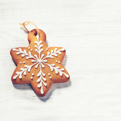 Gingerbread cookies over wooden background.