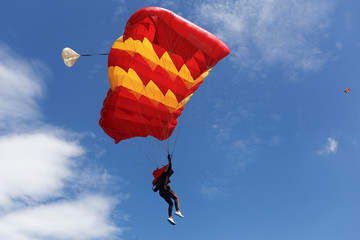 color red parachute in the blue sky